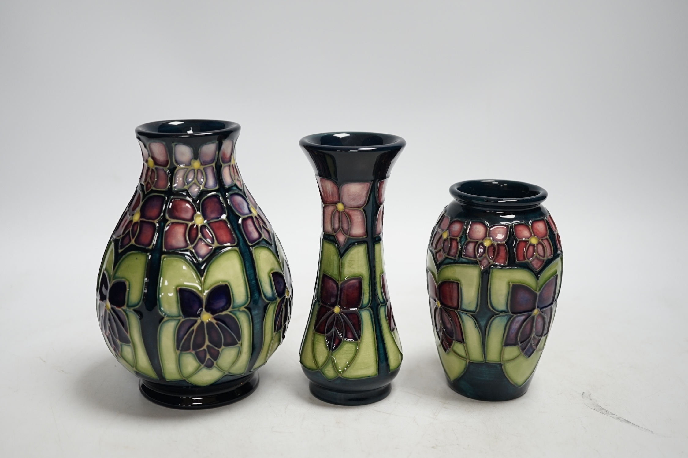 Three Moorcroft violet pattern vases, tallest 13.5cm